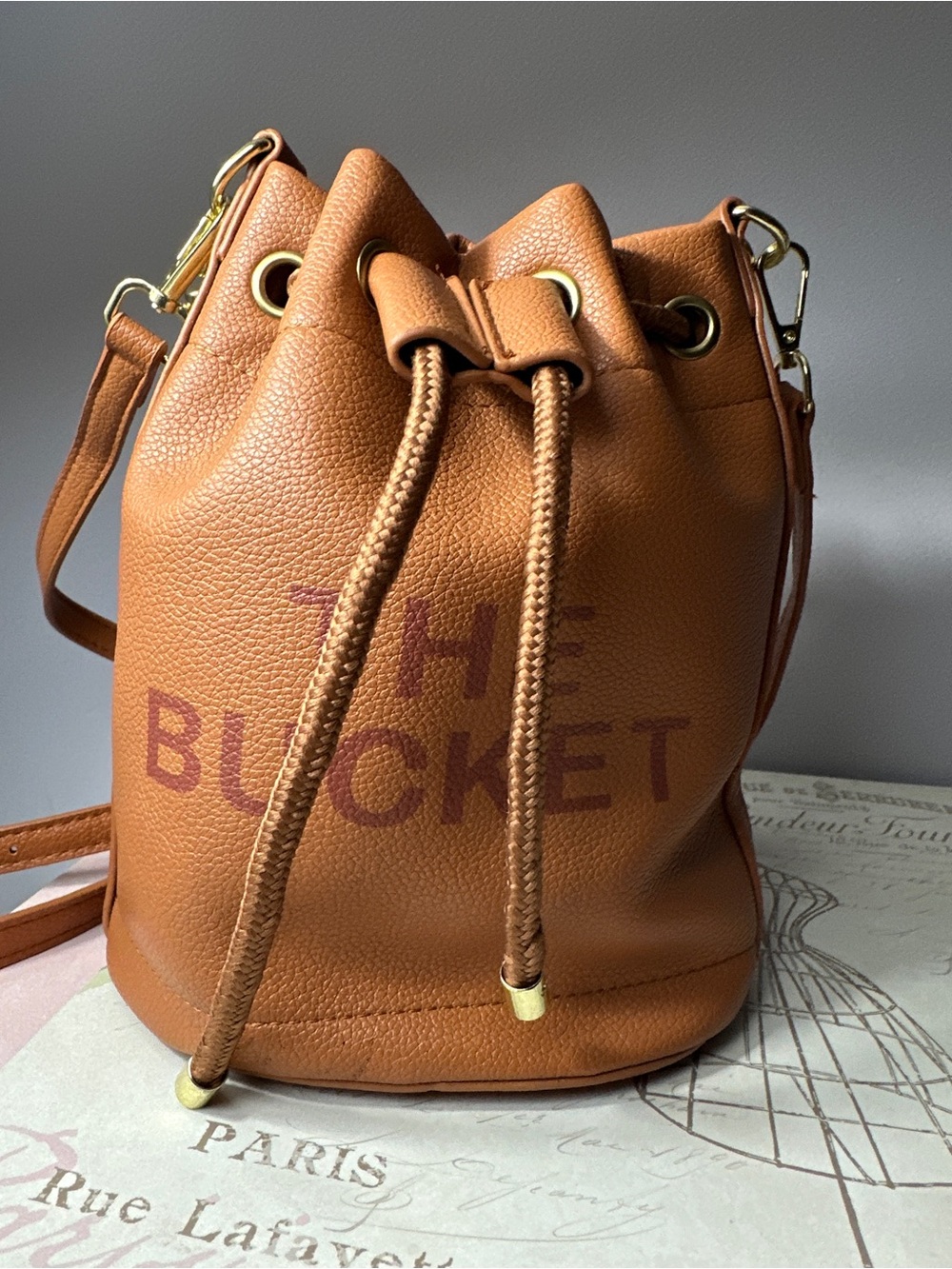 The Bucket mini Tan Drawstring Bucket Bag with adjustable strap